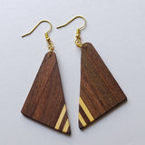Wooden triangle earrings with gold accents on a light gray background